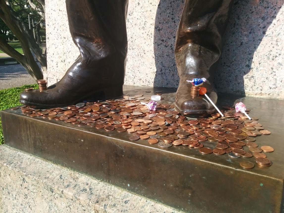 Pennies lying at the foot of a statue